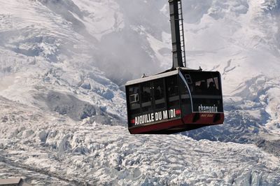 Information sign on snow covered mountain