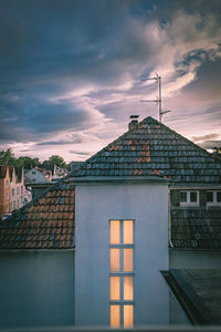 Buildings in city against sky at sunset