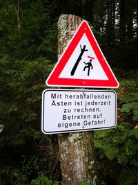 Information sign on road by trees