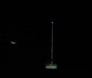 Illuminated lamp against sky at night