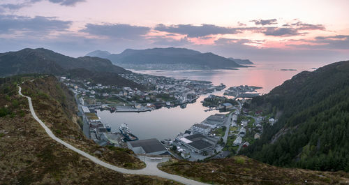 High angle view of buildings and mountains against sky at sunset