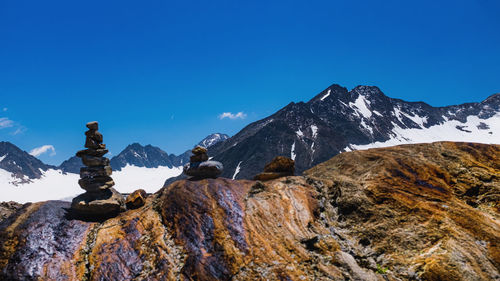 Scenic view of snowcapped mountains against clear blue sky