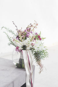 Close-up of pink flower vase on table