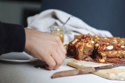 Close-up of person preparing food on cutting board