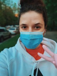 Portrait of beautiful young woman with mask and gloves 