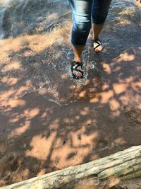 Low section of man with reflection in puddle