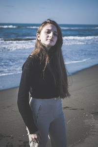 Portrait of teenage girl standing at beach