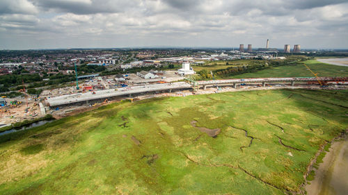 High angle view of cityscape by sea against sky