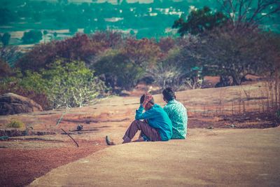 Friends sitting on land