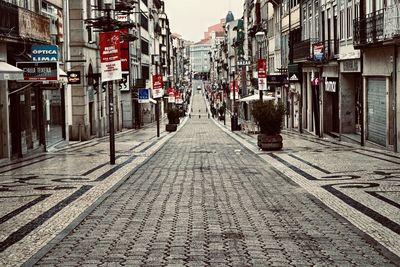 Empty alley amidst buildings in city