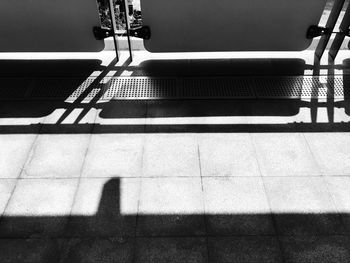 Shadow of railing on staircase in city