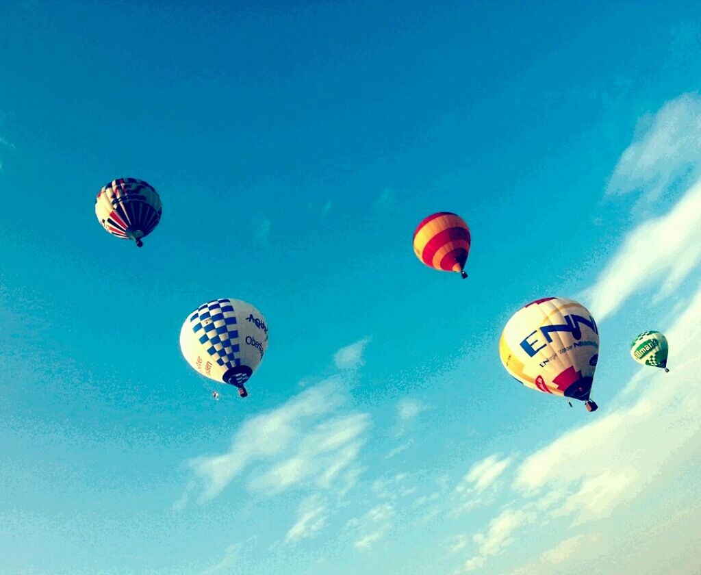 mid-air, parachute, flying, low angle view, extreme sports, paragliding, adventure, hot air balloon, exhilaration, blue, multi colored, parachuting, sky, fun, sport, leisure activity, transportation, freedom, kite, balloon