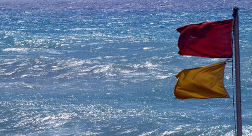 High angle view of red umbrella on sea