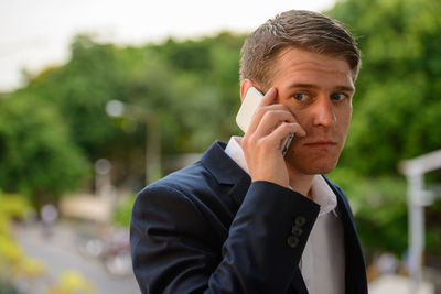 Portrait of young man using mobile phone