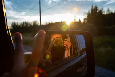 Man photographing through car window