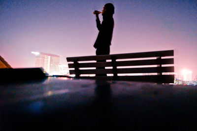 Silhouette man against sky at night