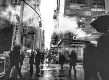 People walking on road along buildings