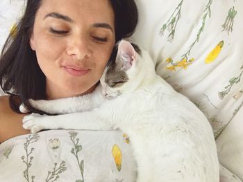 Portrait of young woman lying on bed