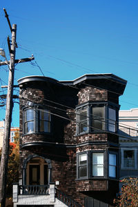 Low angle view of building against clear blue sky