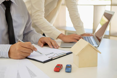 Close-up of business colleagues working in office