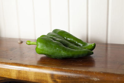 Pair of poblano peppers on a wooden table