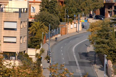 Street amidst trees and plants in city