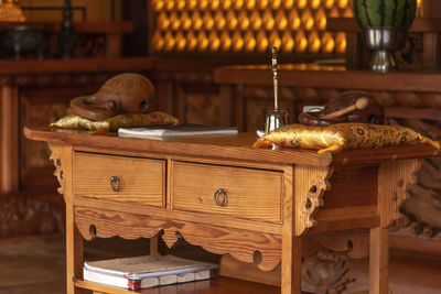 High angle view of antique containers on table