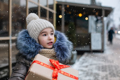 Portrait of smiling young woman in warm clothes