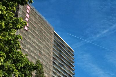 Low angle view of modern building against blue sky