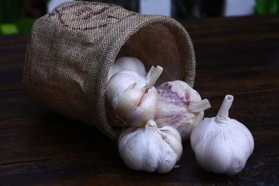 Close-up of garlic spilling on table