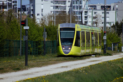 Panoramic shot of railroad tracks by street in city