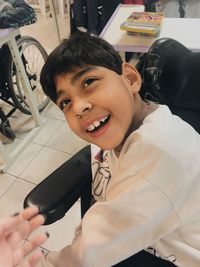 Portrait of smiling boy holding camera