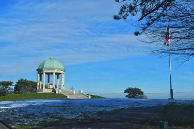 Built structure by sea against sky