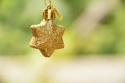 Close-up of rusty metal hanging against blurred background