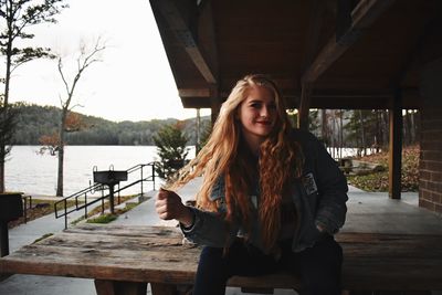 Portrait of smiling young woman standing outdoors