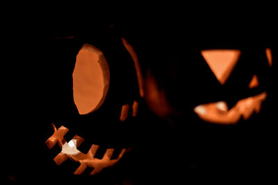 Close-up of illuminated pumpkin against black background