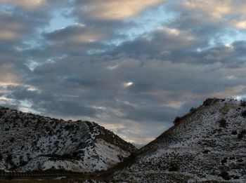 Scenic view of mountains against cloudy sky