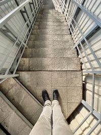 Low section of man standing on staircase