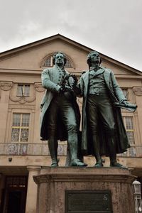 Low angle view of statue against building