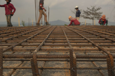 People standing by railroad tracks