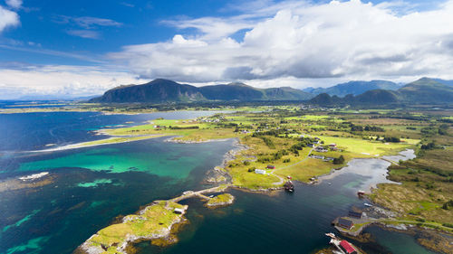 Scenic view of sea and mountains against sky