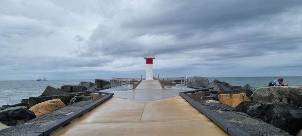 Overcast day with a gorgeous, up close lighthouse by ocean