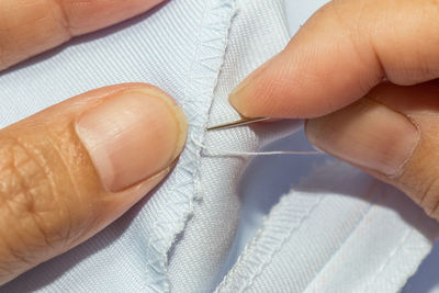 Midsection of tailor sewing textile