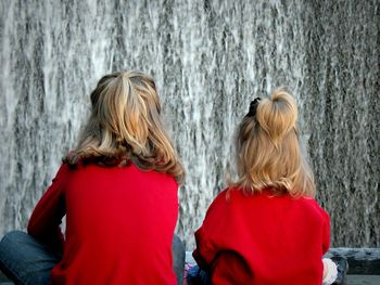 Rear view of two people in rain