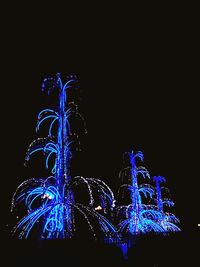 Low angle view of illuminated christmas lights against clear sky