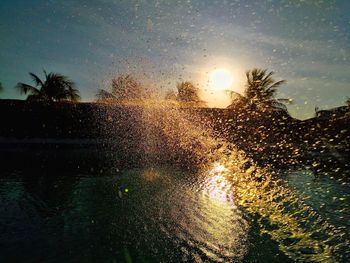 Raindrops on glass window during sunset