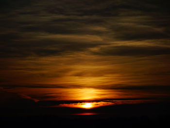 Scenic view of dramatic sky over sea during sunset