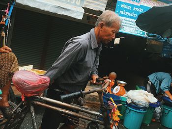 People working at market stall