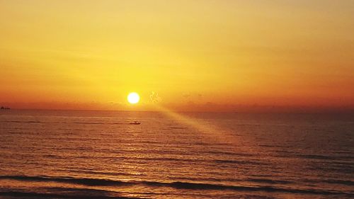 Scenic view of sea against romantic sky at sunset