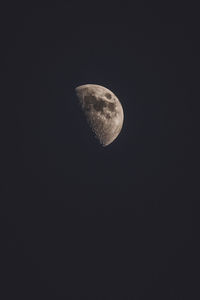 Low angle view of half moon against sky at night